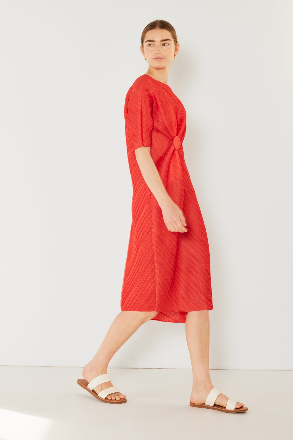 The Pleated Dolman Sleeve Dress is a modern and chic addition to your wardrobe. With its unique dolman sleeves and pleated detailing, this dress offers a stylish and sophisticated look. The relaxed silhouette and pleats create a flattering and comfortable fit.