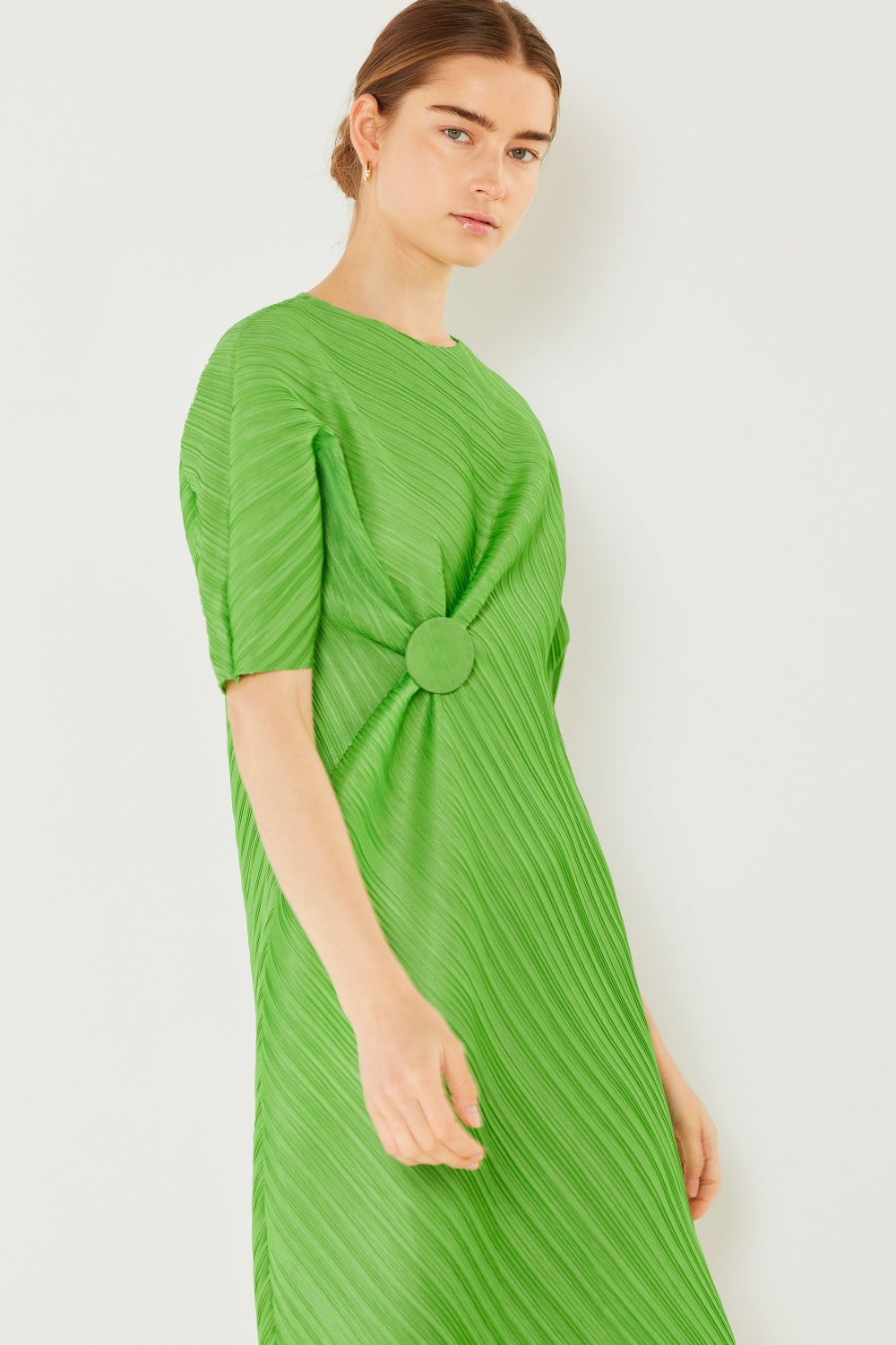The Pleated Dolman Sleeve Dress is a modern and chic addition to your wardrobe. With its unique dolman sleeves and pleated detailing, this dress offers a stylish and sophisticated look. The relaxed silhouette and pleats create a flattering and comfortable fit.
