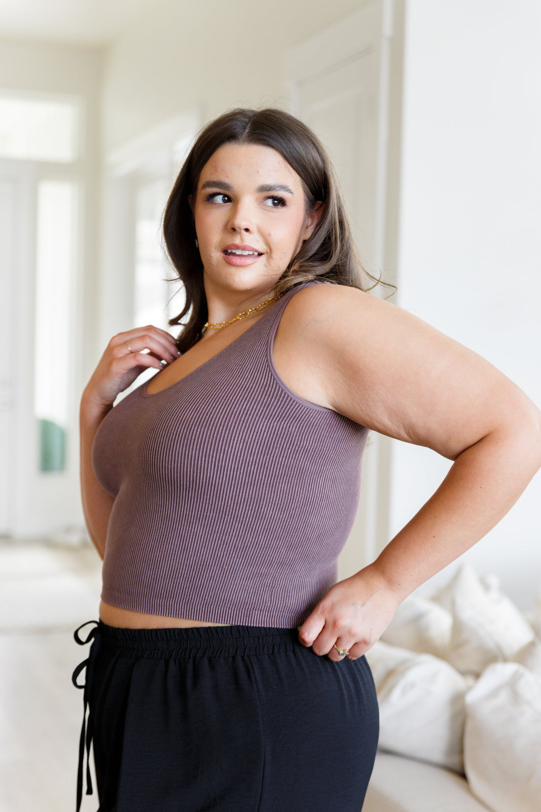 This tank is the perfect combination of function and fashion. Crafted from ribbed fabric with a seamless finish, it offers a flattering, cropped fit that can be customized with your choice of v-neck or scoop neck. Plus, its mineral wash makes it a true stand-out piece.