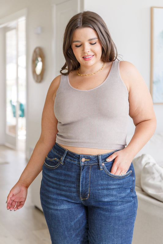 This tank is the perfect combination of function and fashion. Crafted from ribbed fabric with a seamless finish, it offers a flattering, cropped fit that can be customized with your choice of v-neck or scoop neck. Plus, its mineral wash makes it a true stand-out piece. S - 3X