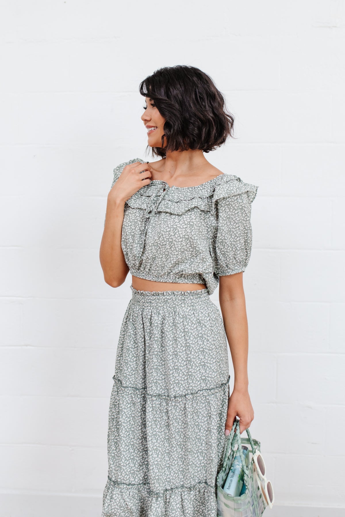 Head to date night in style in the Golden Hour Top! This cute top has all the details that we absolutely love. Featuring a ruffled elasticated neckline, keyhole detail on the front, balloon sleeves with elastic cuffs, and elastic waist. Not to mention it's in the most adorable tiny floral print! Pair with denim, nude sandals, and matching bag for an on trend look! S - 3X