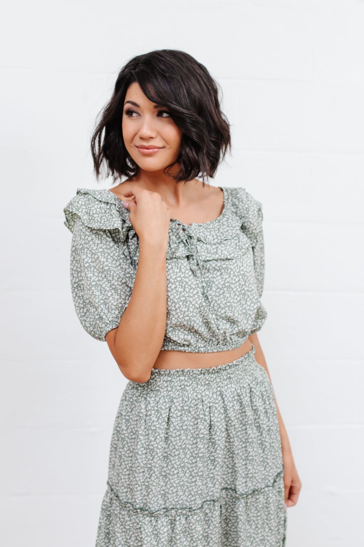 Head to date night in style in the Golden Hour Top! This cute top has all the details that we absolutely love. Featuring a ruffled elasticated neckline, keyhole detail on the front, balloon sleeves with elastic cuffs, and elastic waist. Not to mention it's in the most adorable tiny floral print! Pair with denim, nude sandals, and matching bag for an on trend look! S - 3X