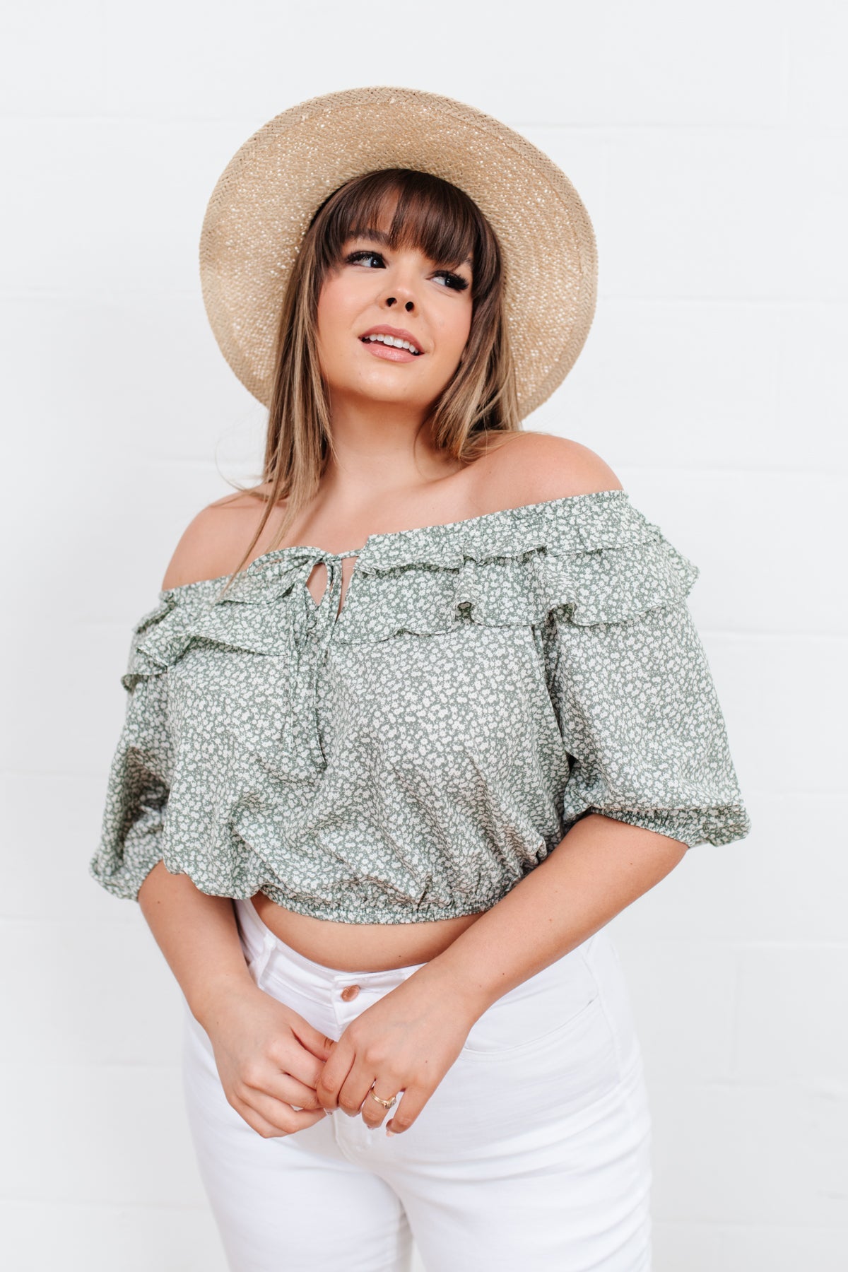 Head to date night in style in the Golden Hour Top! This cute top has all the details that we absolutely love. Featuring a ruffled elasticated neckline, keyhole detail on the front, balloon sleeves with elastic cuffs, and elastic waist. Not to mention it's in the most adorable tiny floral print! Pair with denim, nude sandals, and matching bag for an on trend look! S - 3X