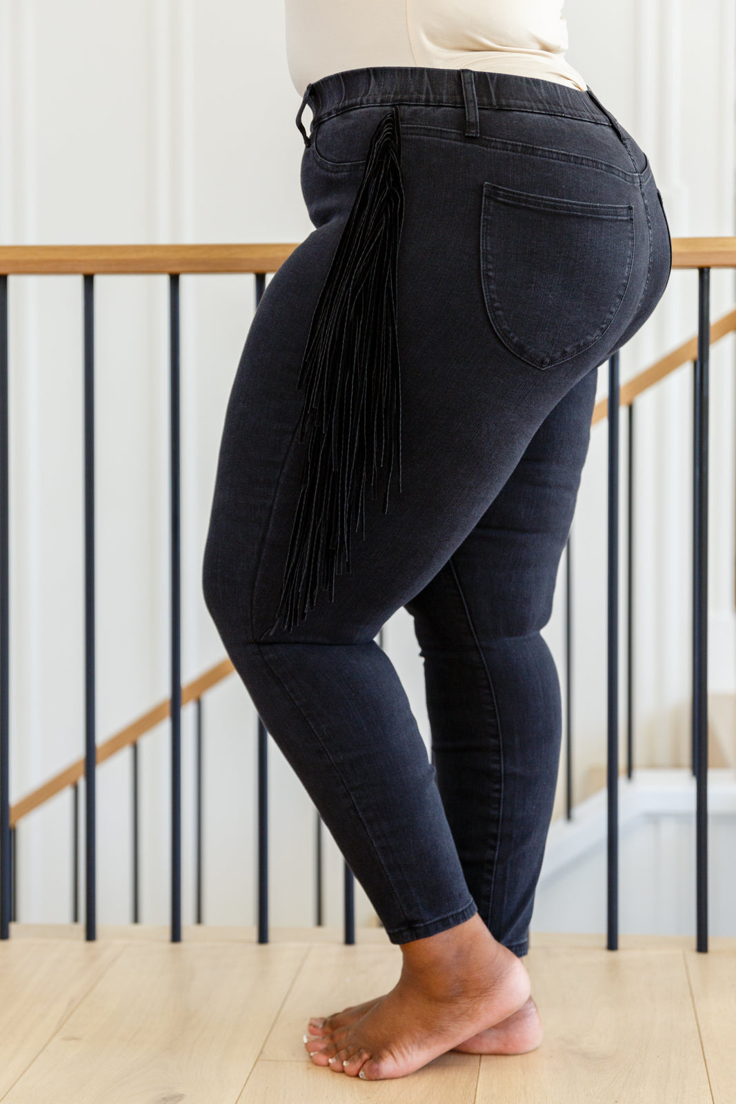 If there's anyone who can totally rock the Hilary Side Fringe Skinny Jegging In Black it's you! These western inspired jeggings feature a mid-rise waist with faux front pockets topping a skinny pant leg. Faux suede fringe decorates either side of these jeans adding a unique and stylish touch. Add cowboy boots and a crop top for a super fun look! 0 - 24W