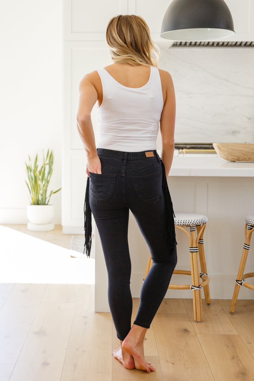 If there's anyone who can totally rock the Hilary Side Fringe Skinny Jegging In Black it's you! These western inspired jeggings feature a mid-rise waist with faux front pockets topping a skinny pant leg. Faux suede fringe decorates either side of these jeans adding a unique and stylish touch. Add cowboy boots and a crop top for a super fun look! 0 - 24W
