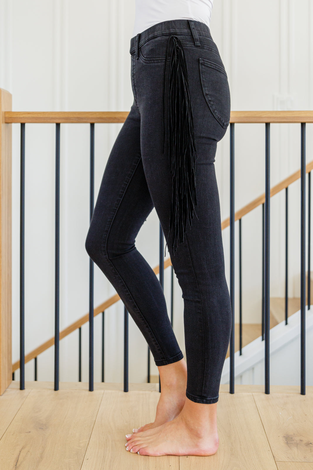 If there's anyone who can totally rock the Hilary Side Fringe Skinny Jegging In Black it's you! These western inspired jeggings feature a mid-rise waist with faux front pockets topping a skinny pant leg. Faux suede fringe decorates either side of these jeans adding a unique and stylish touch. Add cowboy boots and a crop top for a super fun look! 0 - 24W