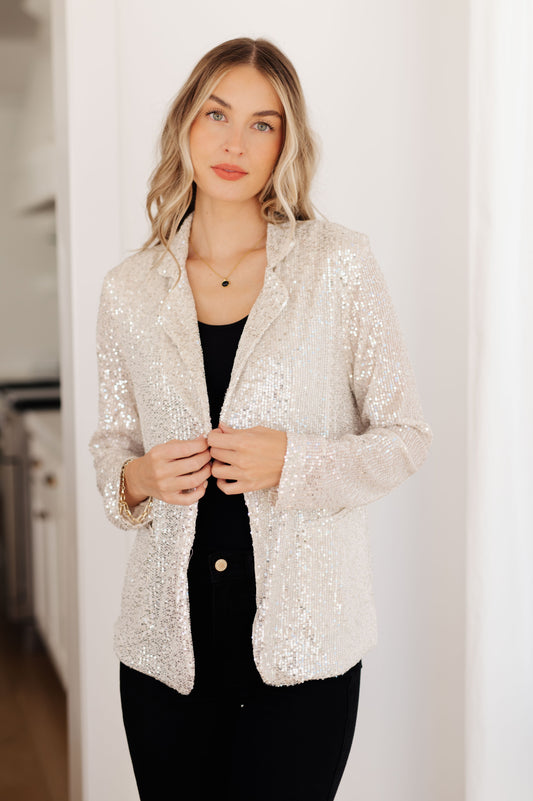 This I Know You're Busy Sequin Blazer will make you a showstopper! Crafted with an all-over silver sequin fabric, this blazer features a notched lapel, pockets, and a relaxed fit. Perfect for a fun evening look! S - 3X