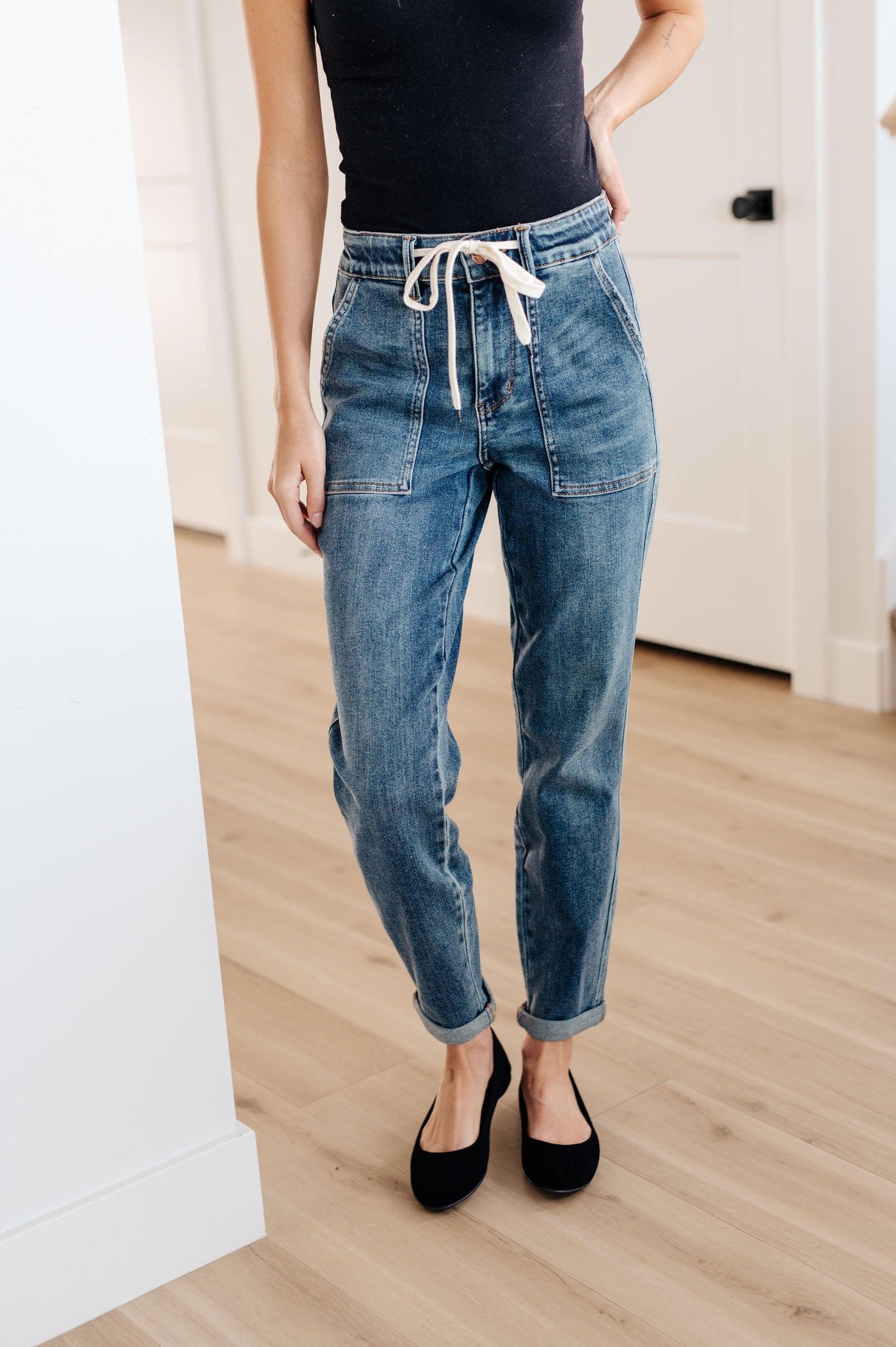 Experience the perfect fit and style in the Payton Pull-On Denim Joggers from Judy Blue! Made with a high rise and zero distressing, these medium-wash joggers offer an elastic waistband, functional drawstring, and patch pockets for a comfortable, adjustable fit. With an optional rolled cuff, you'll look and feel effortlessly chic. Are you ready to feel confident and stylish? Try Payton Pull-On Denim Joggers today! 0 - 24W
