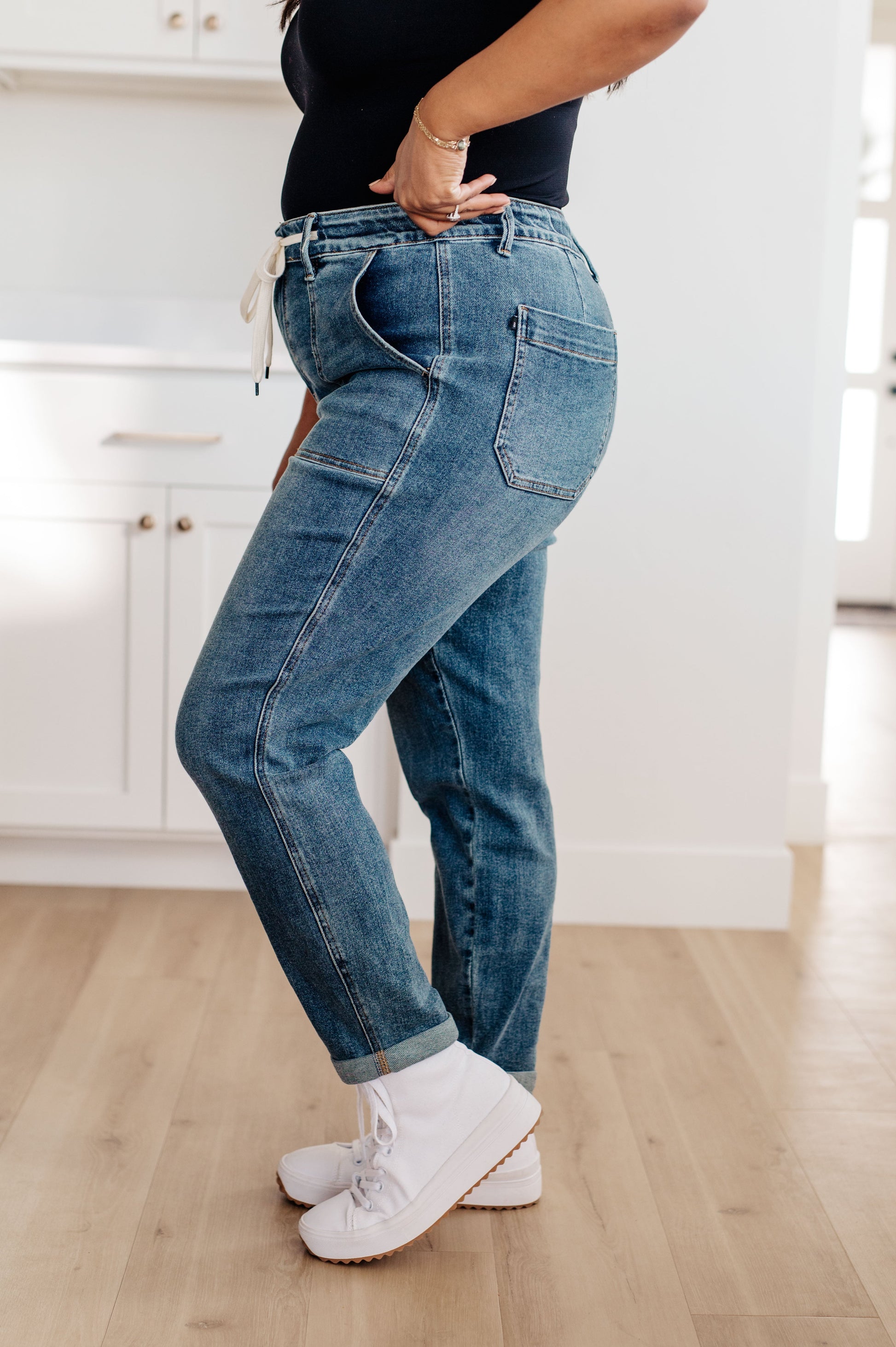 Experience the perfect fit and style in the Payton Pull-On Denim Joggers from Judy Blue! Made with a high rise and zero distressing, these medium-wash joggers offer an elastic waistband, functional drawstring, and patch pockets for a comfortable, adjustable fit. With an optional rolled cuff, you'll look and feel effortlessly chic. Are you ready to feel confident and stylish? Try Payton Pull-On Denim Joggers today! 0 -24W