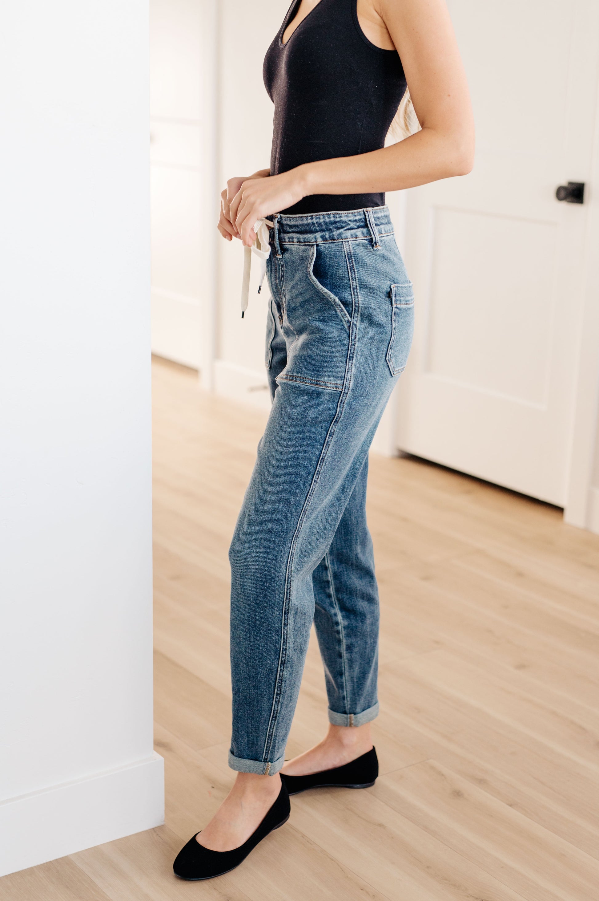 Experience the perfect fit and style in the Payton Pull-On Denim Joggers from Judy Blue! Made with a high rise and zero distressing, these medium-wash joggers offer an elastic waistband, functional drawstring, and patch pockets for a comfortable, adjustable fit. With an optional rolled cuff, you'll look and feel effortlessly chic. Are you ready to feel confident and stylish? Try Payton Pull-On Denim Joggers today! 0 -24W