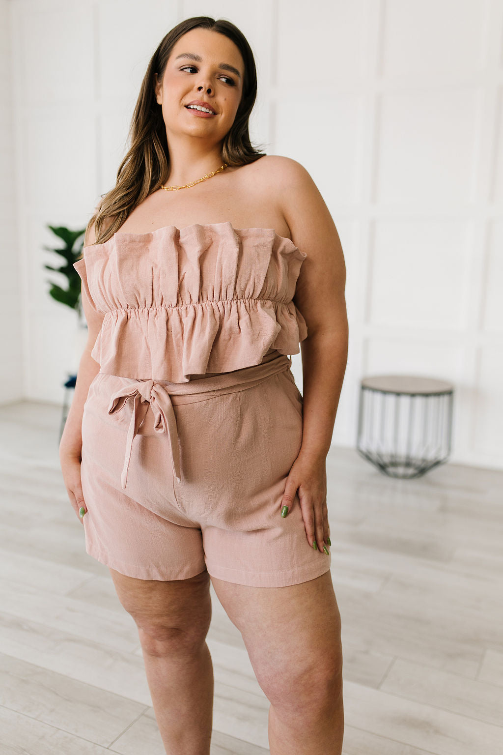 Let the Pink Skies Romper take you from day to night in style! This amazing strapless piece has adorable details like the ruffle pleated bust, tie waist, side pockets and shorts! Pair this with heels and a blazer for a daytime look then strip the blazer for date night! S - 3X