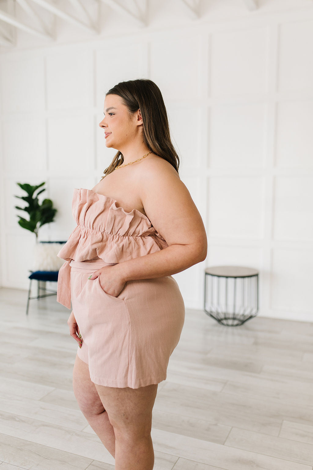 Let the Pink Skies Romper take you from day to night in style! This amazing strapless piece has adorable details like the ruffle pleated bust, tie waist, side pockets and shorts! Pair this with heels and a blazer for a daytime look then strip the blazer for date night! S - 3X