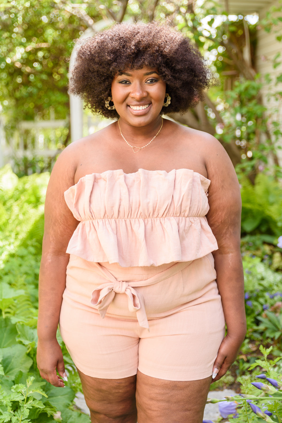 Let the Pink Skies Romper take you from day to night in style! This amazing strapless piece has adorable details like the ruffle pleated bust, tie waist, side pockets and shorts! Pair this with heels and a blazer for a daytime look then strip the blazer for date night! S - 3X