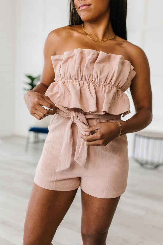 Let the Pink Skies Romper take you from day to night in style! This amazing strapless piece has adorable details like the ruffle pleated bust, tie waist, side pockets and shorts! Pair this with heels and a blazer for a daytime look then strip the blazer for date night! S - 3X