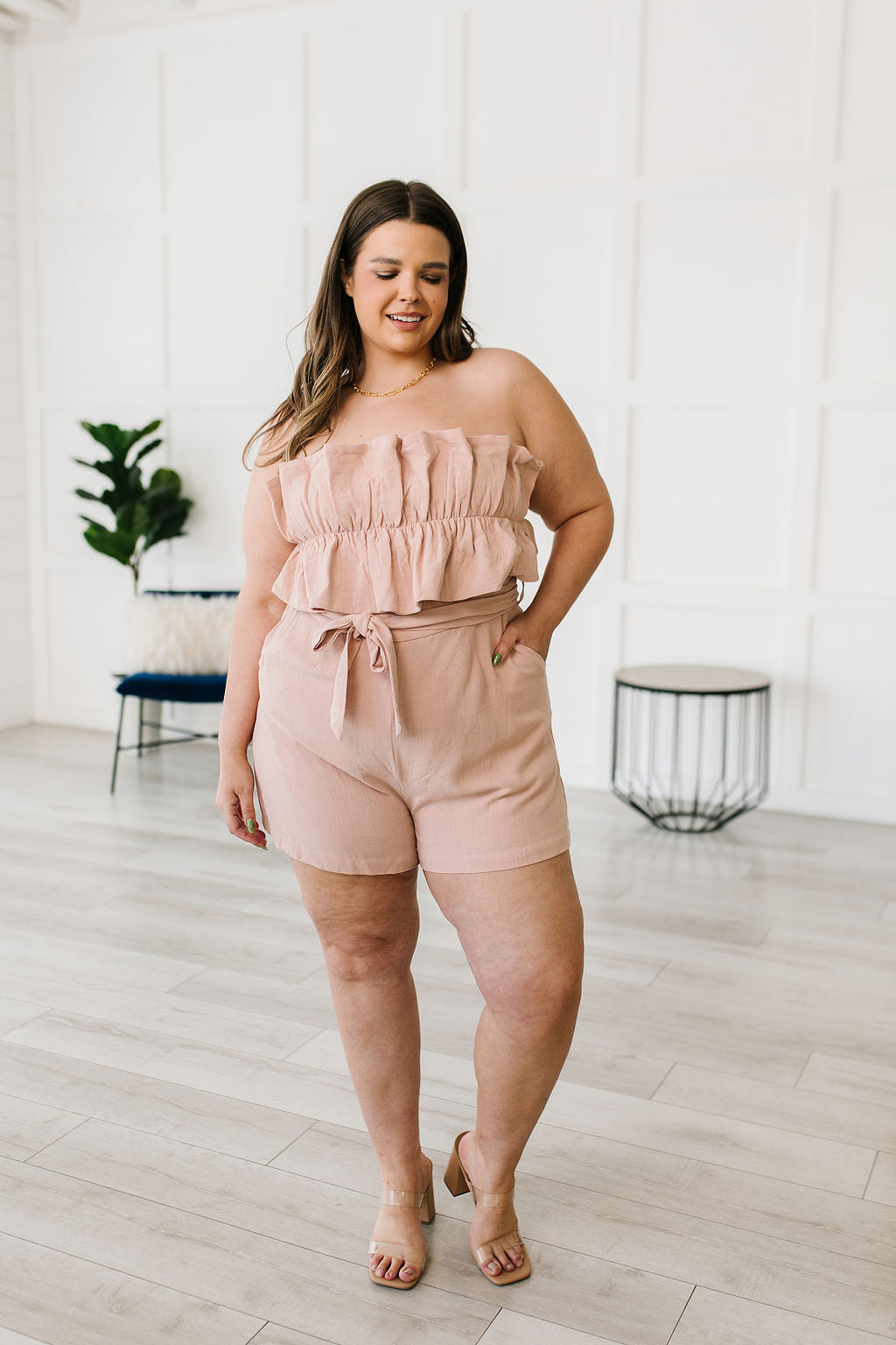 Let the Pink Skies Romper take you from day to night in style! This amazing strapless piece has adorable details like the ruffle pleated bust, tie waist, side pockets and shorts! Pair this with heels and a blazer for a daytime look then strip the blazer for date night! S - 3X