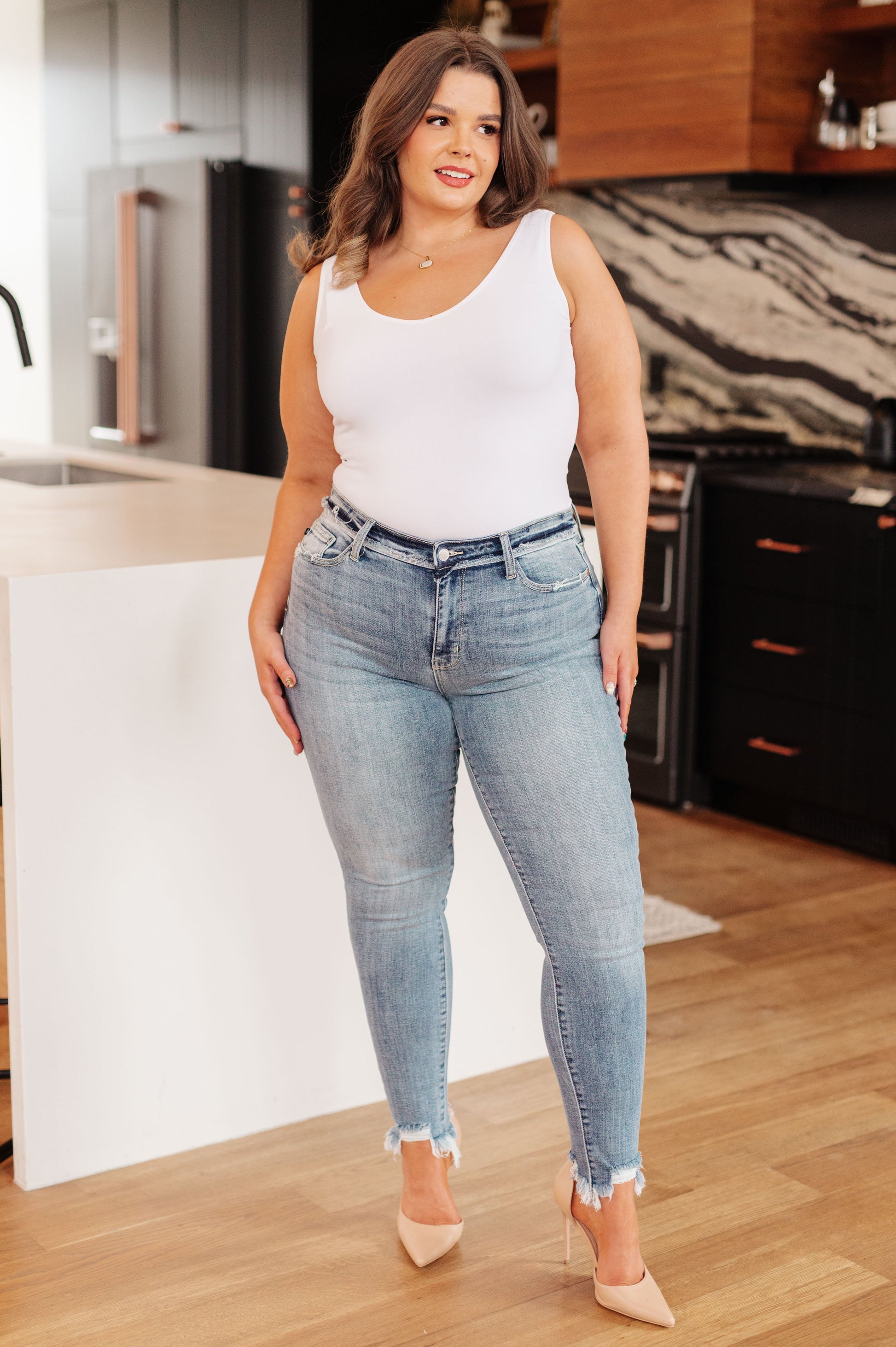The Sherry Mid Rise Release Waistband Detail Skinny from Judy Blue are perfect for everyday style. Featuring a medium wash, flattering mid rise fit, and raw edge release waistband detail that all come together for a look that is casual and modern. The skinny fit and raw hemline complete the look.
