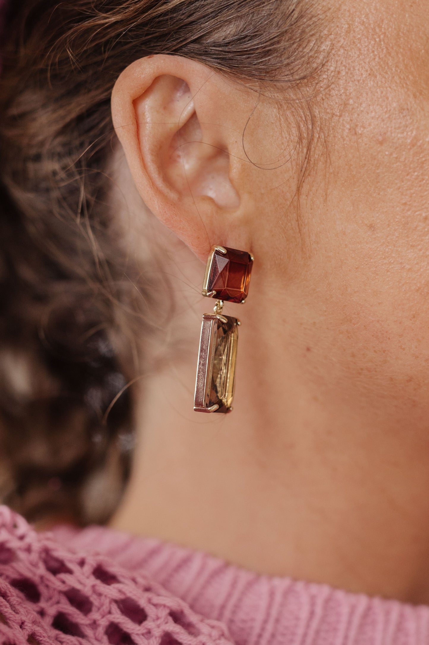 Make a stylish statement with these Sparkly Spirit Drop Crystal Earrings. Featuring mounted crystal stones and post earrings, they provide a stunning pop of color for any look.