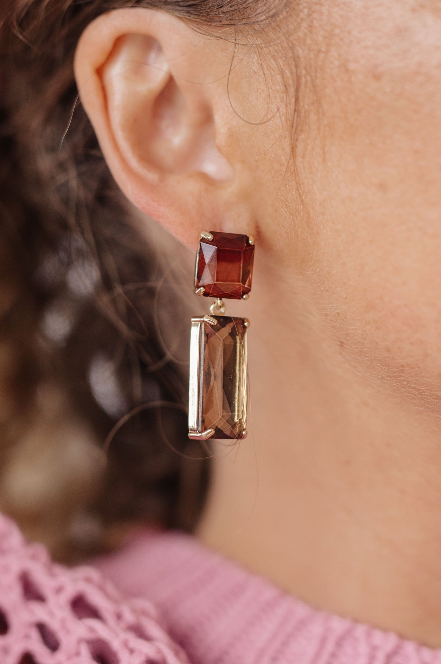 Make a stylish statement with these Sparkly Spirit Drop Crystal Earrings. Featuring mounted crystal stones and post earrings, they provide a stunning pop of color for any look.