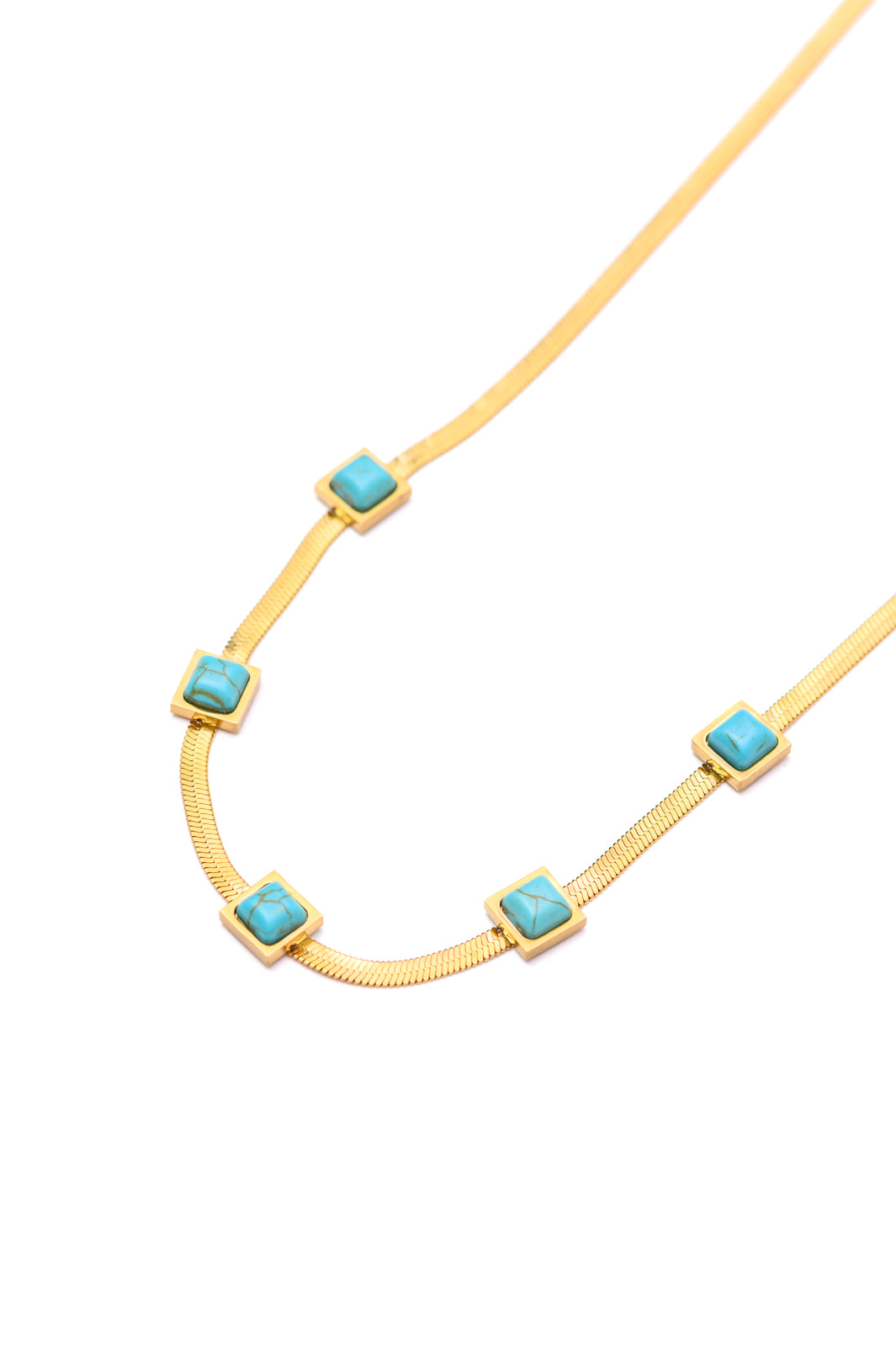 This Turquoise Squares Necklace is the perfect combination of modern and classic. The five fixed turquoise squares are set against a gold herringbone necklace, for a look that expertly combines timeless and trendy. Wear it to your next party and be the star of the night! 18K gold plated stainless steel means you can wear this piece to the beach, the pool, or even working out without worrying over tarnishing, green marks, or skin irritation.