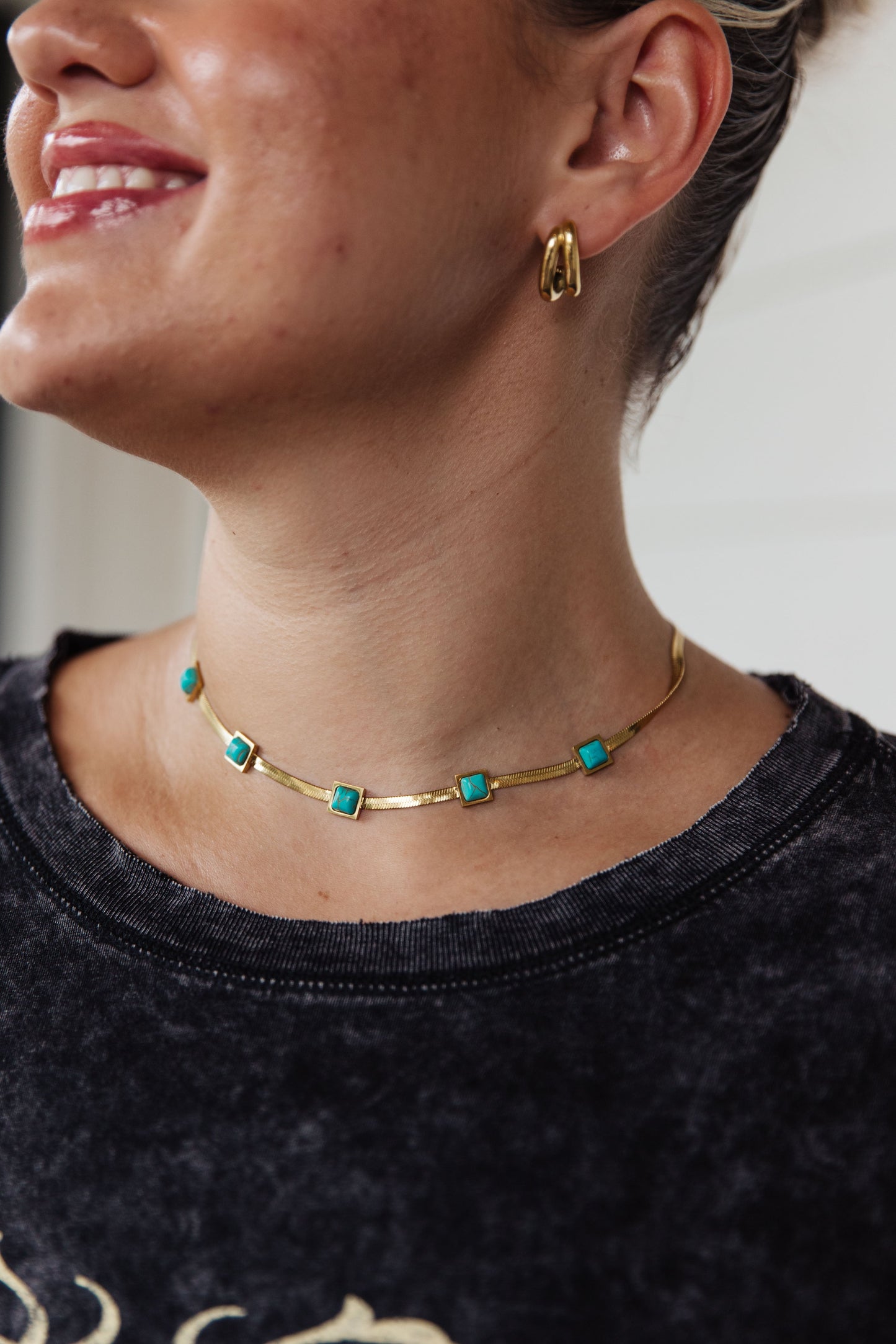 This Turquoise Squares Necklace is the perfect combination of modern and classic. The five fixed turquoise squares are set against a gold herringbone necklace, for a look that expertly combines timeless and trendy. Wear it to your next party and be the star of the night! 18K gold plated stainless steel means you can wear this piece to the beach, the pool, or even working out without worrying over tarnishing, green marks, or skin irritation.