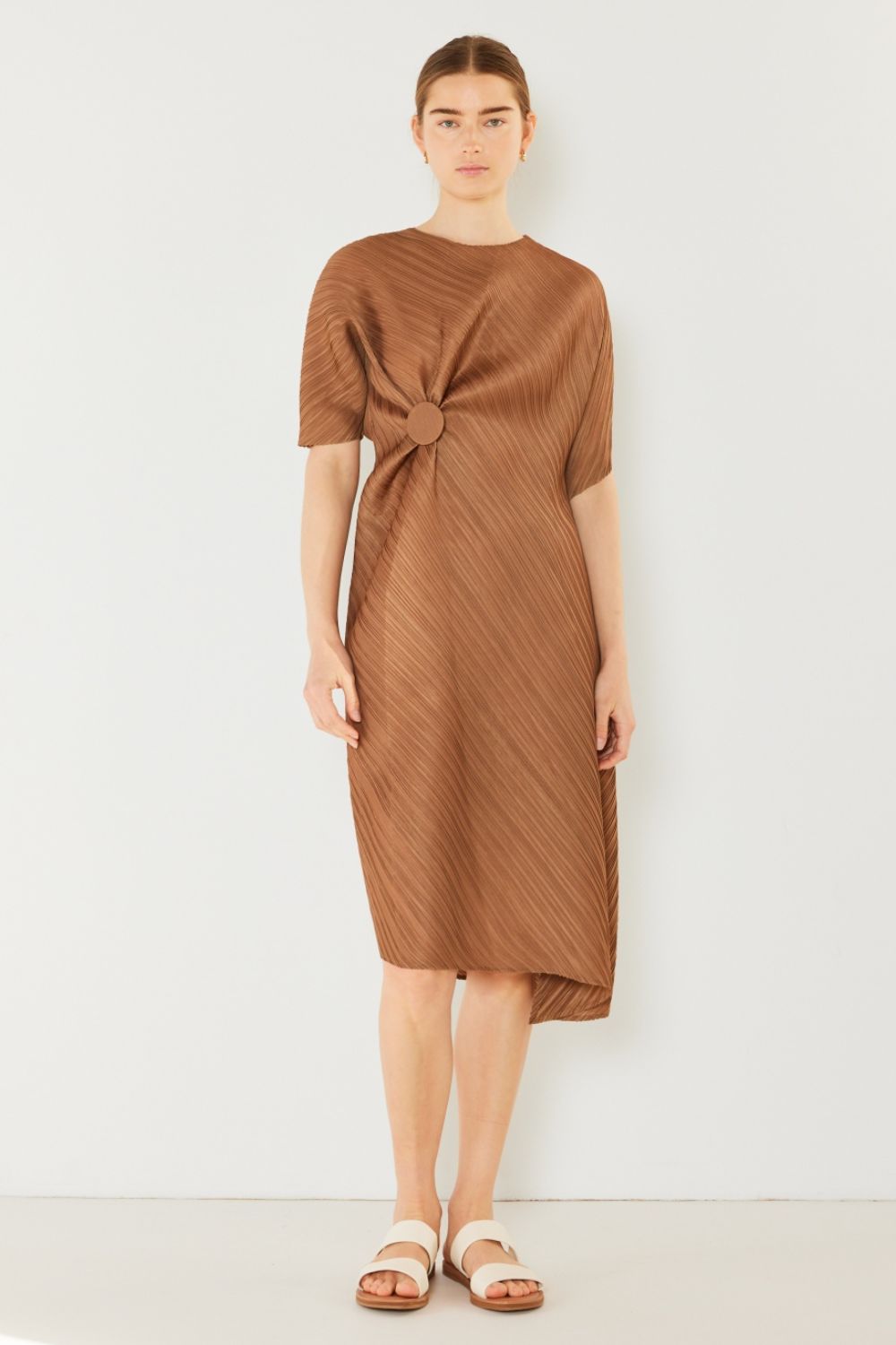 The Pleated Dolman Sleeve Dress is a modern and chic addition to your wardrobe. With its unique dolman sleeves and pleated detailing, this dress offers a stylish and sophisticated look. The relaxed silhouette and pleats create a flattering and comfortable fit.