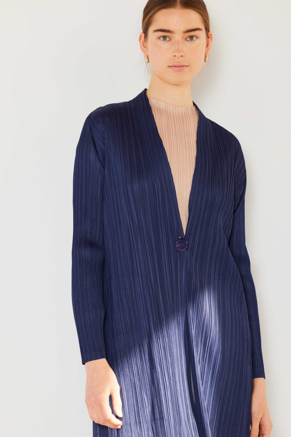 The Pleated Long Sleeve Cardigan is a versatile and chic layering piece for your wardrobe. With its pleated detailing and long sleeves, this cardigan offers a stylish and sophisticated look. The pleats add texture and visual interest to the classic cardigan design.
