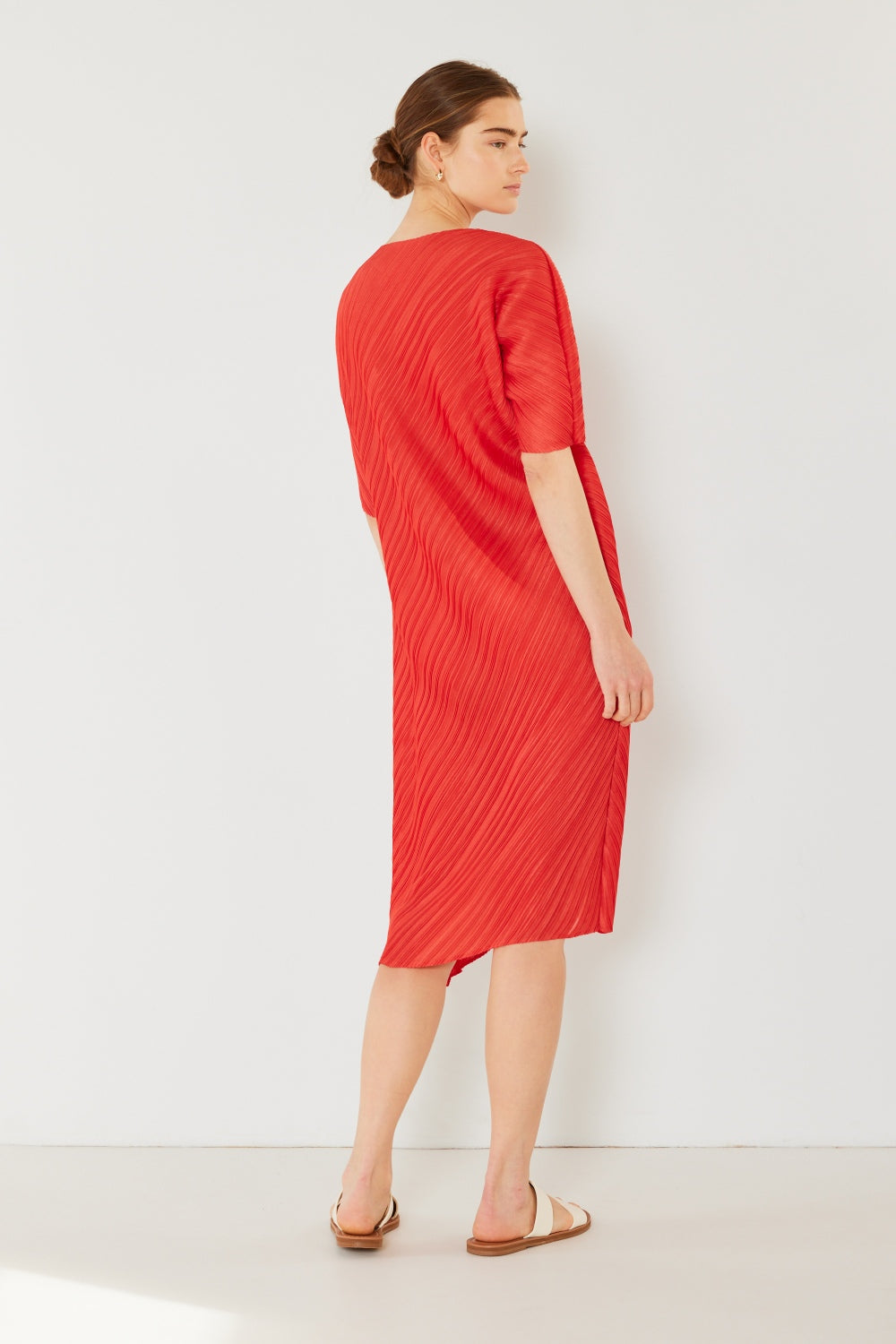 The Pleated Dolman Sleeve Dress is a modern and chic addition to your wardrobe. With its unique dolman sleeves and pleated detailing, this dress offers a stylish and sophisticated look. The relaxed silhouette and pleats create a flattering and comfortable fit.