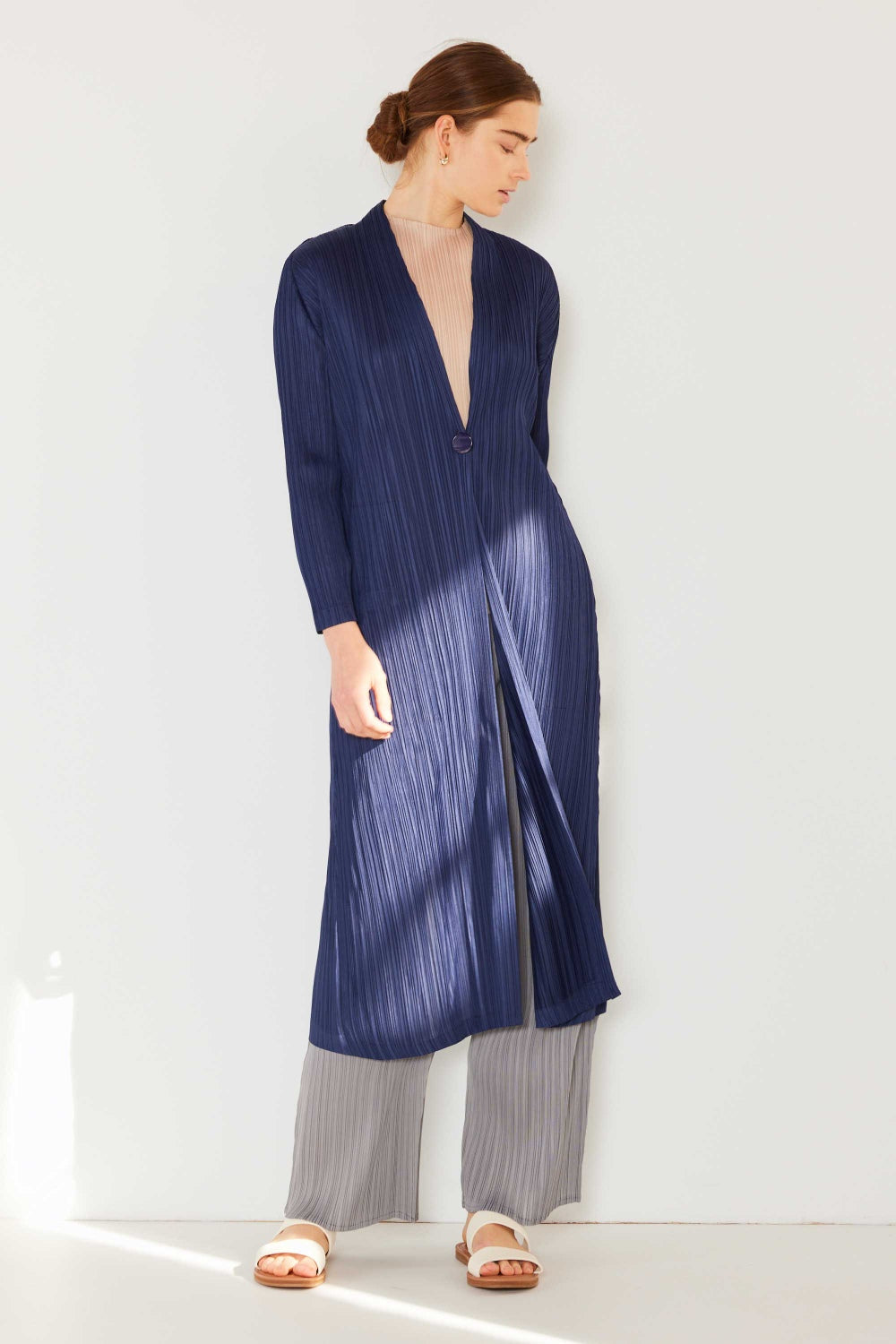 The Pleated Long Sleeve Cardigan is a versatile and chic layering piece for your wardrobe. With its pleated detailing and long sleeves, this cardigan offers a stylish and sophisticated look. The pleats add texture and visual interest to the classic cardigan design.