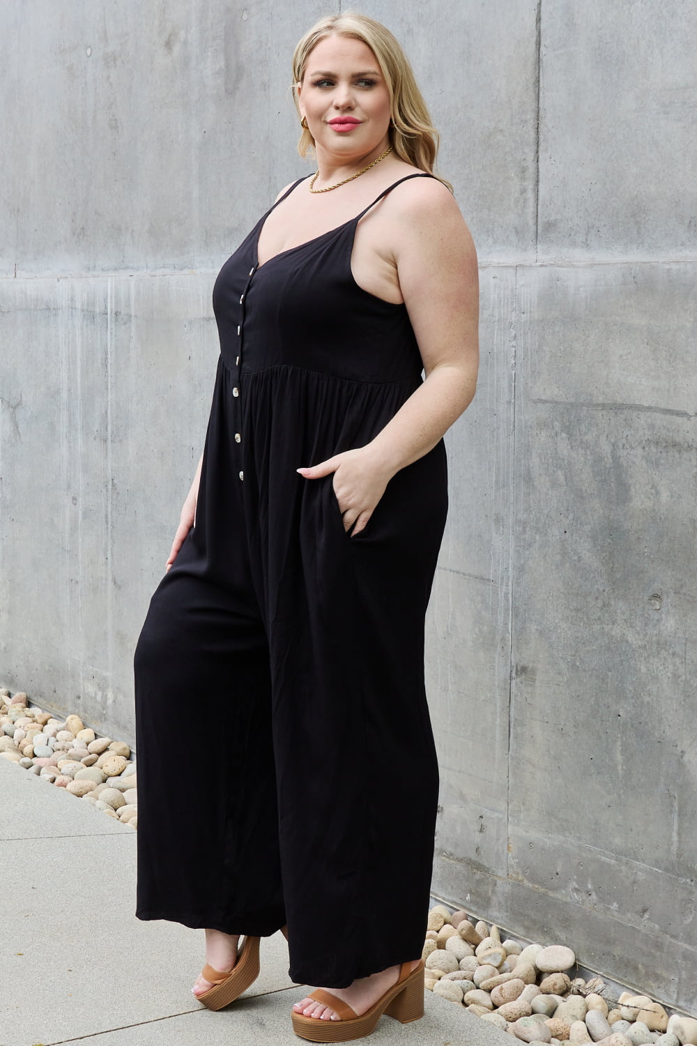 This jumpsuit is designed to be your go-to outfit for any occasion, whether you're running errands, attending a casual gathering, or simply lounging at home. This jumpsuit features a wide leg silhouette that not only offers a chic and contemporary look but also allows for unrestricted movement.