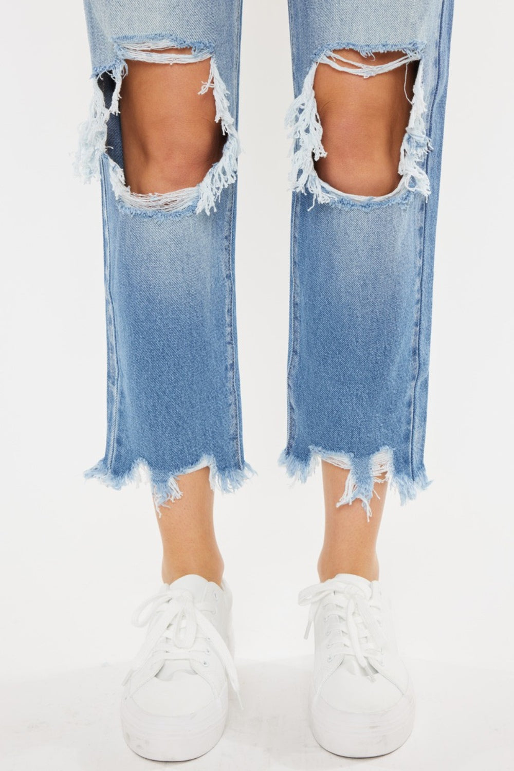 High Waist Chewed Up Straight Mom Jeans are the ultimate combination of vintage-inspired style and trendy edge. These jeans, with their high waistline, provide a flattering and comfortable fit that accentuates your curves.