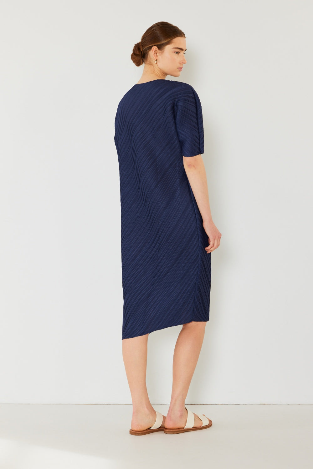 The Pleated Dolman Sleeve Dress is a modern and chic addition to your wardrobe. With its unique dolman sleeves and pleated detailing, this dress offers a stylish and sophisticated look. The relaxed silhouette and pleats create a flattering and comfortable fit.