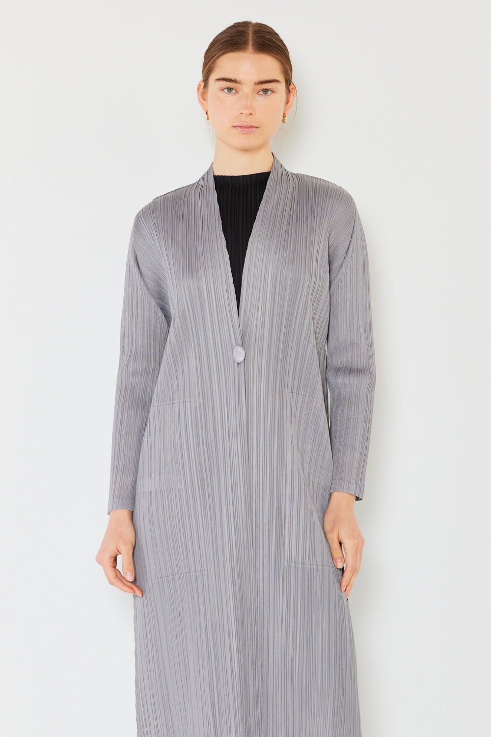 The Pleated Long Sleeve Cardigan is a versatile and chic layering piece for your wardrobe. With its pleated detailing and long sleeves, this cardigan offers a stylish and sophisticated look. The pleats add texture and visual interest to the classic cardigan design.