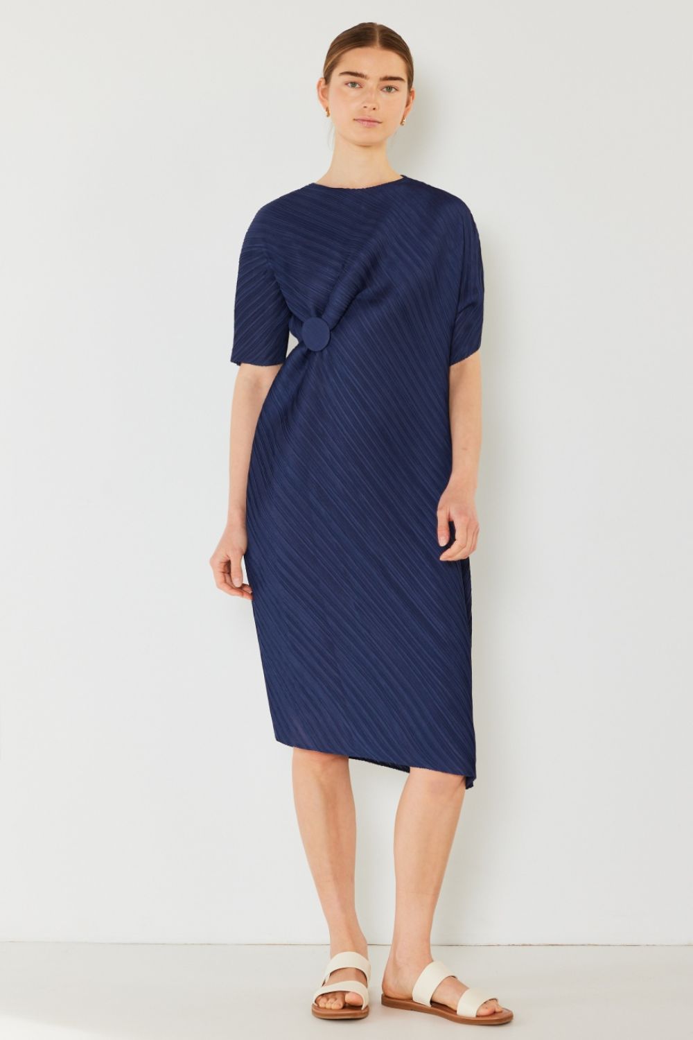 The Pleated Dolman Sleeve Dress is a modern and chic addition to your wardrobe. With its unique dolman sleeves and pleated detailing, this dress offers a stylish and sophisticated look. The relaxed silhouette and pleats create a flattering and comfortable fit.