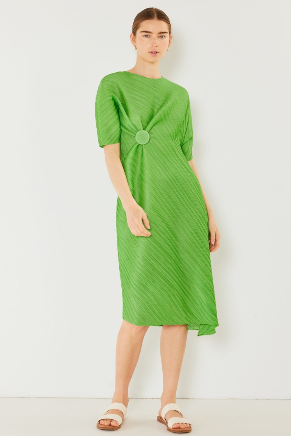 The Pleated Dolman Sleeve Dress is a modern and chic addition to your wardrobe. With its unique dolman sleeves and pleated detailing, this dress offers a stylish and sophisticated look. The relaxed silhouette and pleats create a flattering and comfortable fit.