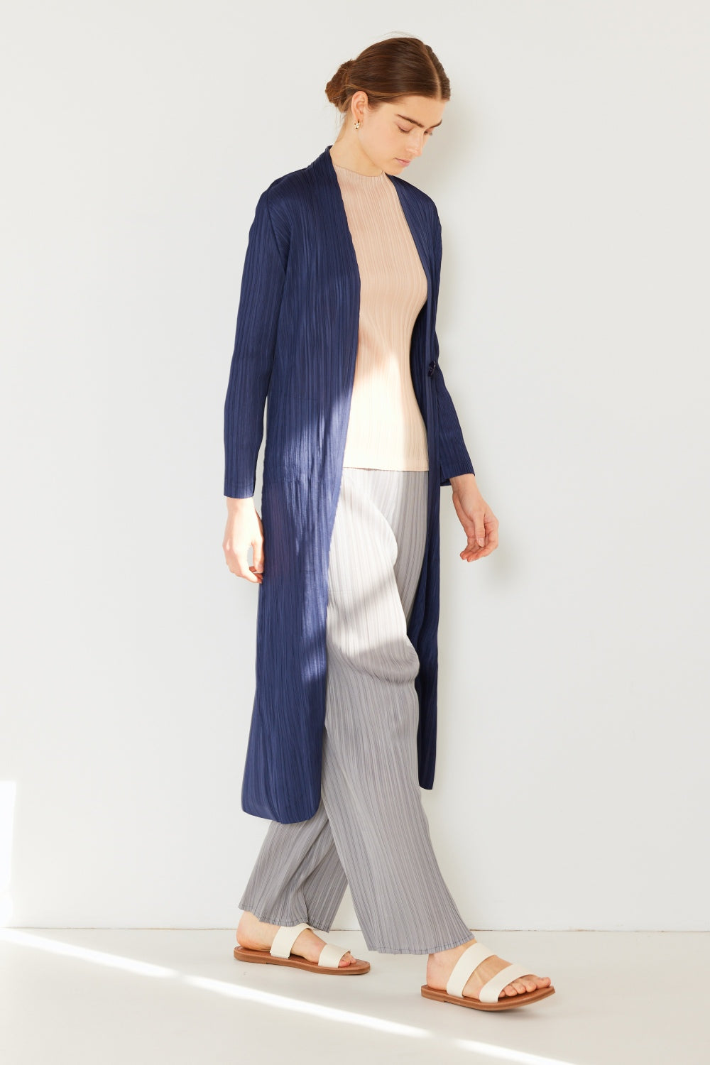 The Pleated Long Sleeve Cardigan is a versatile and chic layering piece for your wardrobe. With its pleated detailing and long sleeves, this cardigan offers a stylish and sophisticated look. The pleats add texture and visual interest to the classic cardigan design.