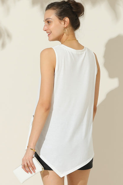 The Buttoned Uneven Hem Tank is a stylish and contemporary addition to your summer wardrobe. With its button-front design and uneven hemline, this tank top offers a unique and trendy look. The button detailing adds a touch of sophistication, while the uneven hemline adds an element of asymmetry and visual interest.  S - XL