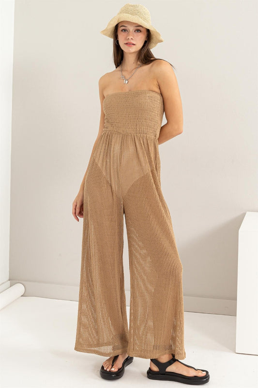 Introducing the Knitted Cover-Up Jumpsuit. This stylish piece combines the comfort of a jumpsuit with the cozy appeal of knitted fabric. The cover-up design adds a layer of sophistication, making it suitable for various occasions. S - L