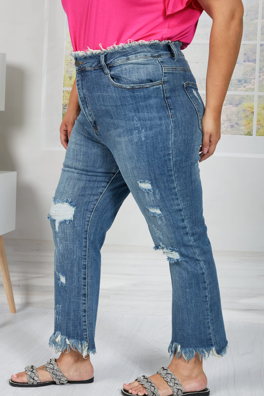 These straight leg jeans really amplify the "undone" look that you're trying to achieve. Not only do these jeans have distressing details throughout the body of the jeans, and at the hem, but also at the waist! To emphasize that unique feature, wear these jeans with a crop top. These are a medium wash. Sizes 5-11.
