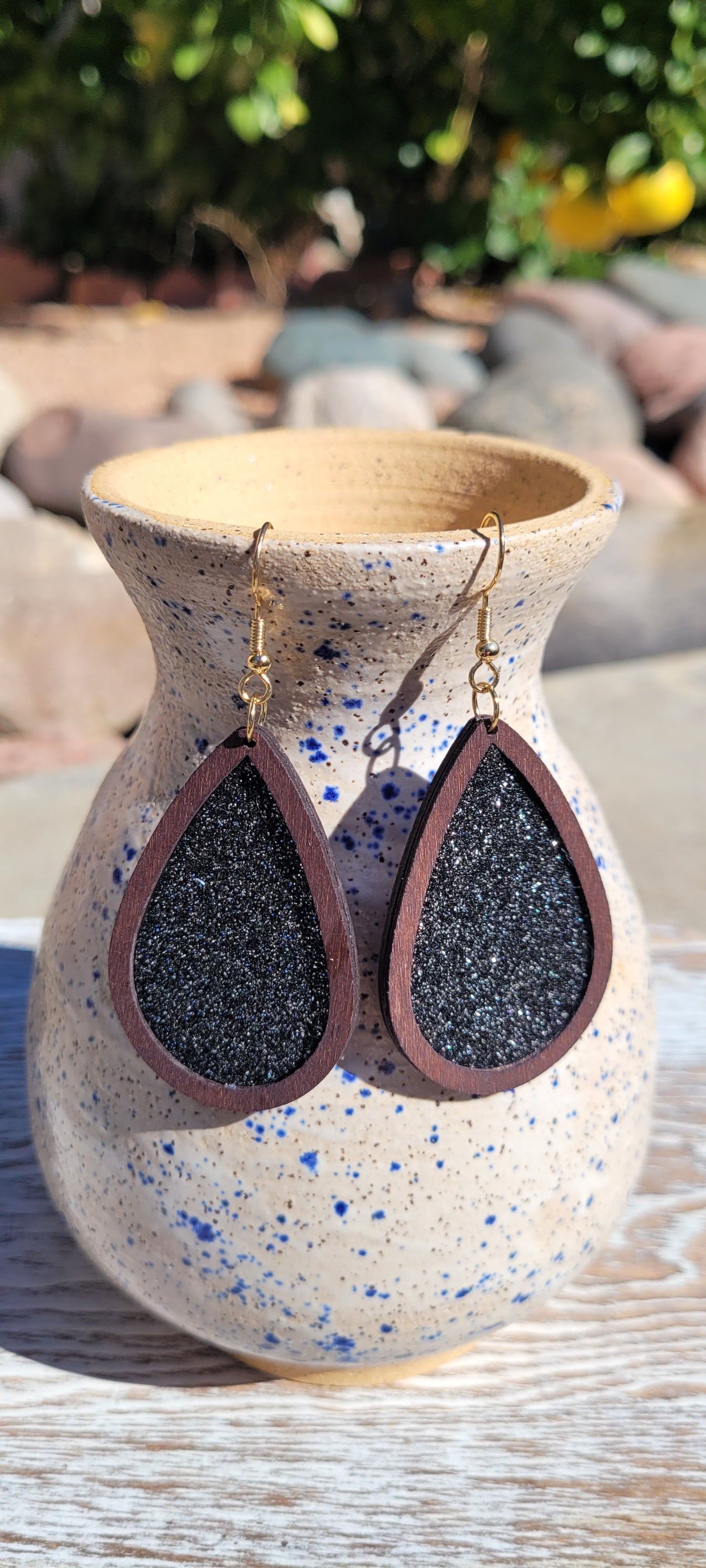 Dark brown wood Black glitter Teardrop shape Brushed gold fish hook dangle earrings Rubber earring back Length 2”, width 1.33” Whether you want to be on the wild side or classy this earring set it will add a fun touch to your outfit