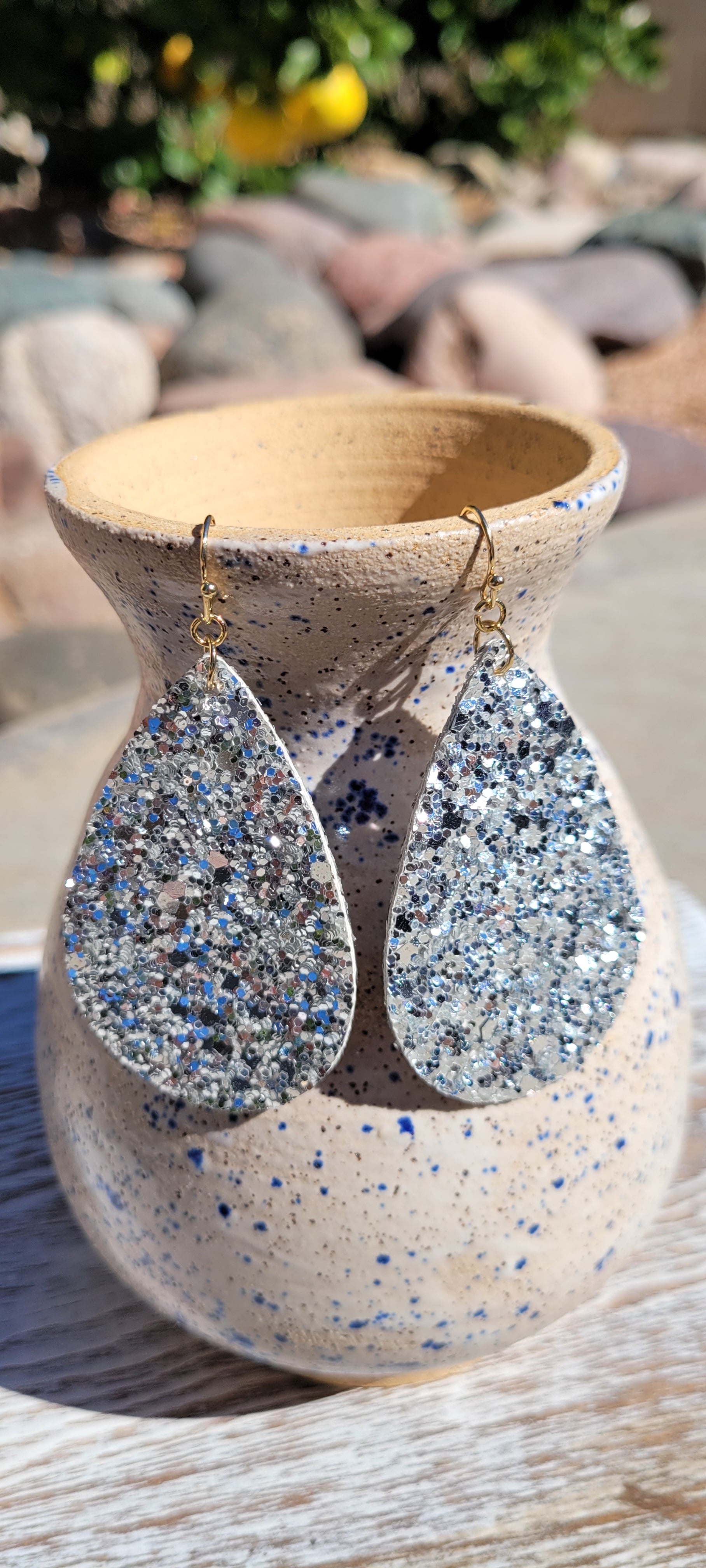 Teardrop shape Silver glitter and sequins Brushed gold fish hook dangle earrings Rubber earring back Length 3” Whether you want to be on the wild side or classy this earring set it will add a fun touch to your outfit