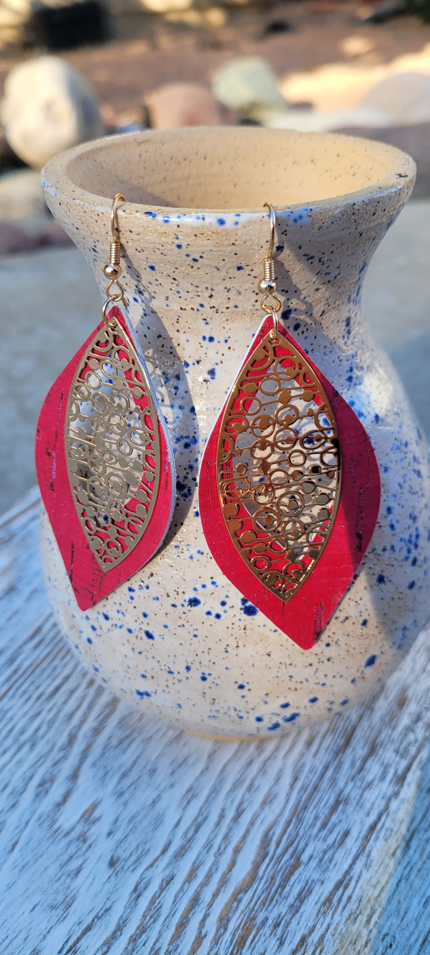 Marquise shape Genuine leather Fuchsia cork print on leather Brushed gold circle and dots design Brushed gold fish hook dangle earrings Rubber earring back Whether you want to be on the wild side or classy this earring set it will add a fun touch to your outfit