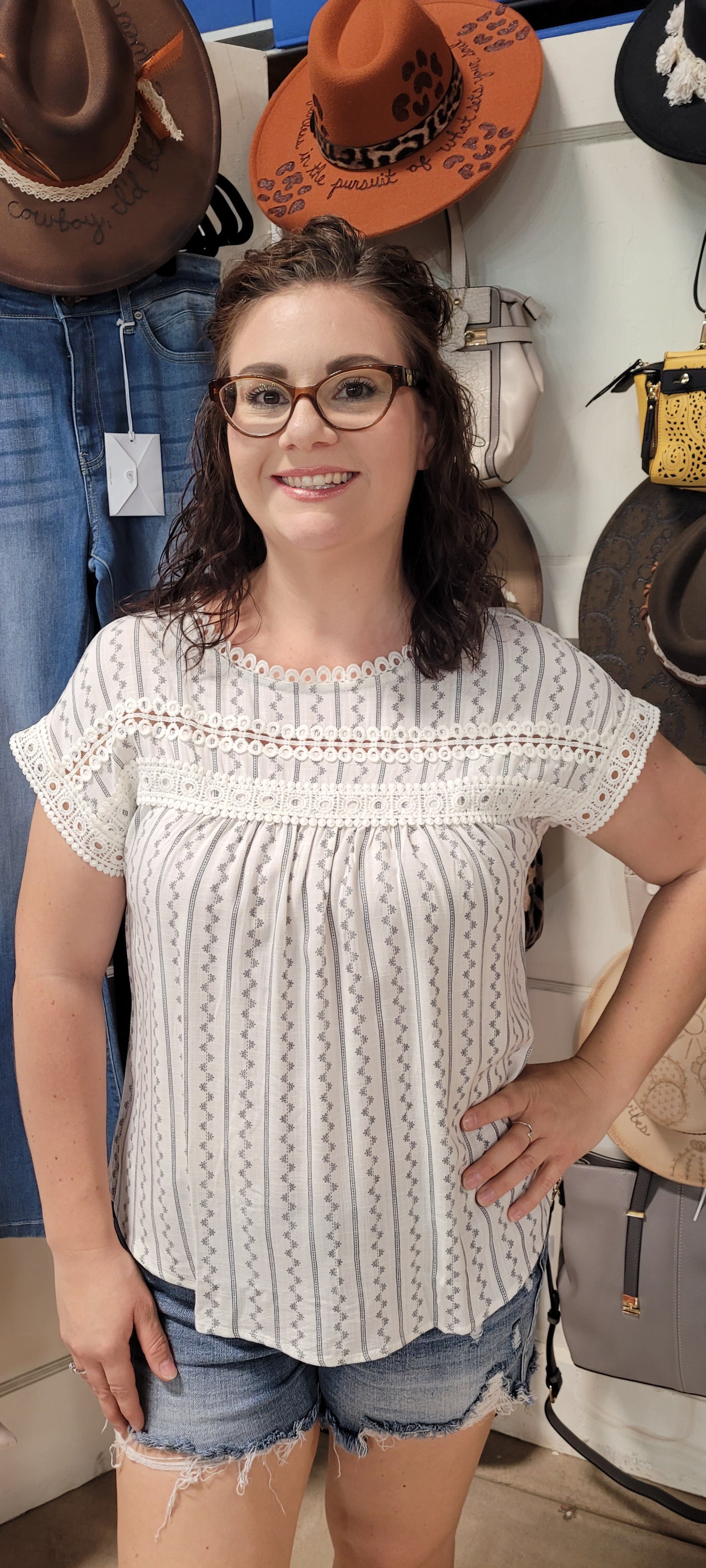 Feel flirty and fun in our Zig Zag Top! This cute top has an eye catching lace trim round neckline, extended shoulders, and dolman sleeves with lace trim. Plus, the front lace inset detail and back non-functional buttons will keep heads turning! Who says fashion can't be playful? Sashay into the room in this statement piece! Sizes small through large.