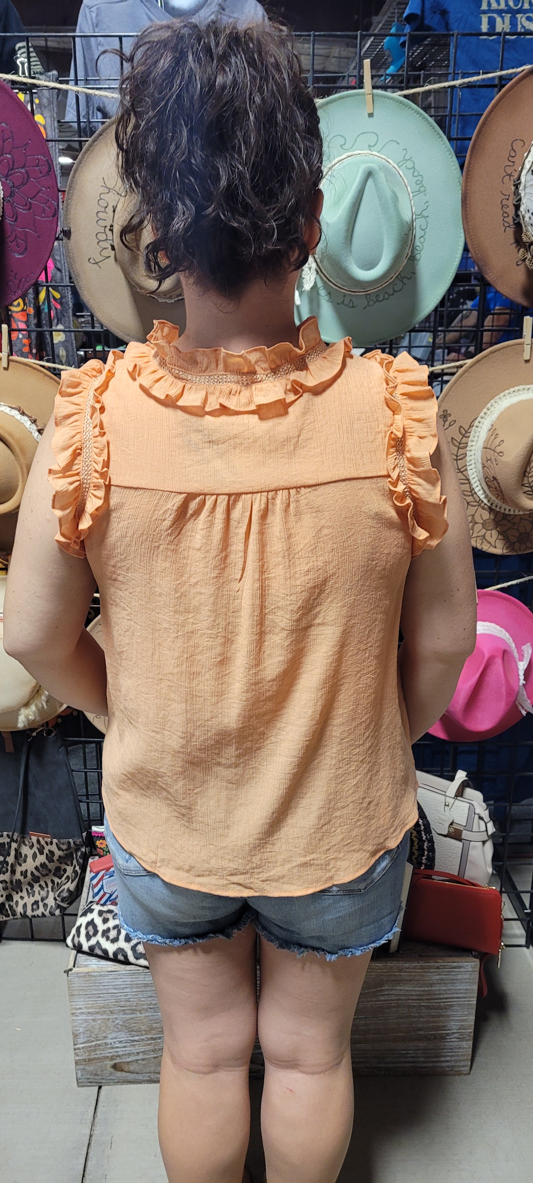 Make a splash this summer with this "Fun In The Sun Dusty Apricot" top! Indulge in the split neckline with self tie, and dance the day away with the ruffles and lace detail that flutter along the neck and arm openings. Time to unleash your carefree summer spirit! Sizes small through large.