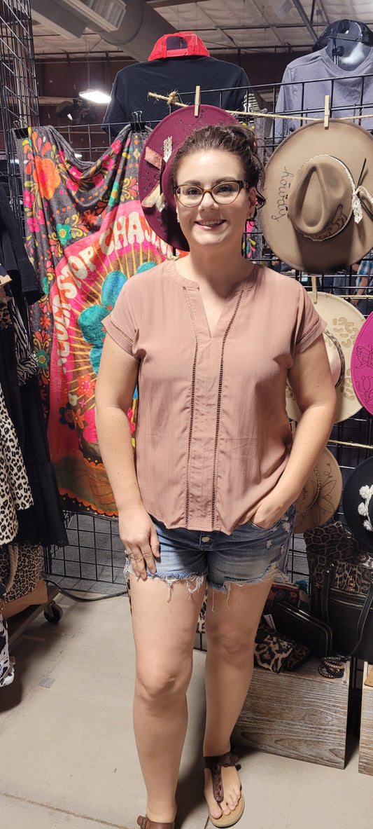 This top is a must-have for any fashionista! It's the perfect blend of chic and subtle boho style with its split neck, ladder lace trim, and short sleeves. Pop on this terracotta beauty and you'll be ready to turn heads at any occasion! #Yasss Sizes small through large.