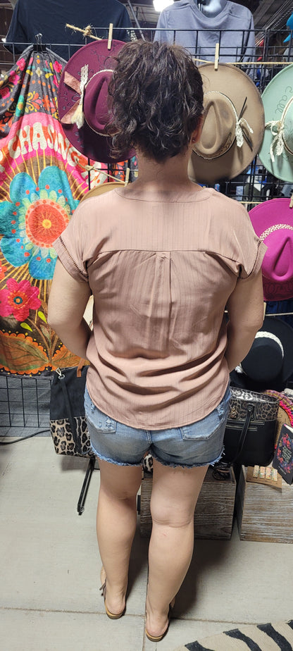 This top is a must-have for any fashionista! It's the perfect blend of chic and subtle boho style with its split neck, ladder lace trim, and short sleeves. Pop on this terracotta beauty and you'll be ready to turn heads at any occasion! #Yasss Sizes small through large.