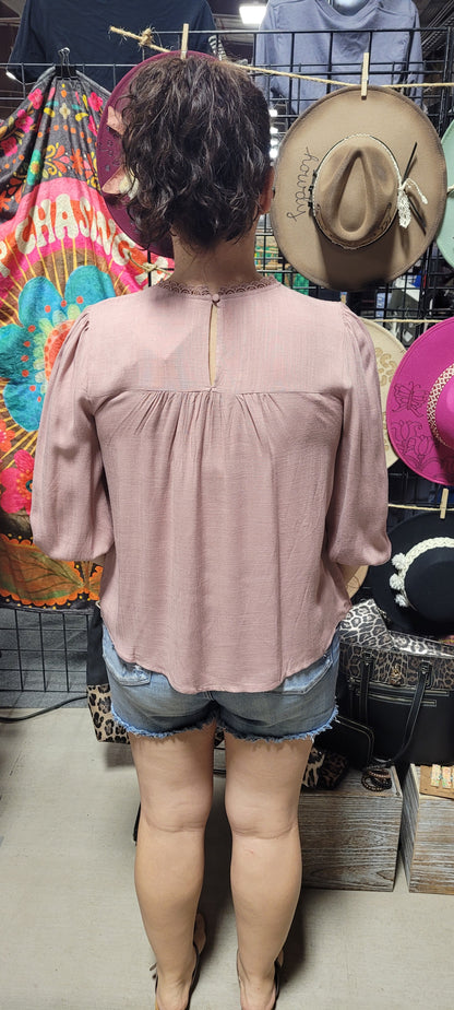 Rock your look with this ravishing&nbsp;top that'll take your fashion to the next level! With its elegant lace mock neck, stylish back-button closure with keyhole, and oh-so-pretty front lace inset and pleated bubble sleeves, you'll be sure to draw admiring glances wherever you go. Let's get fabulous! Sizes small through large.