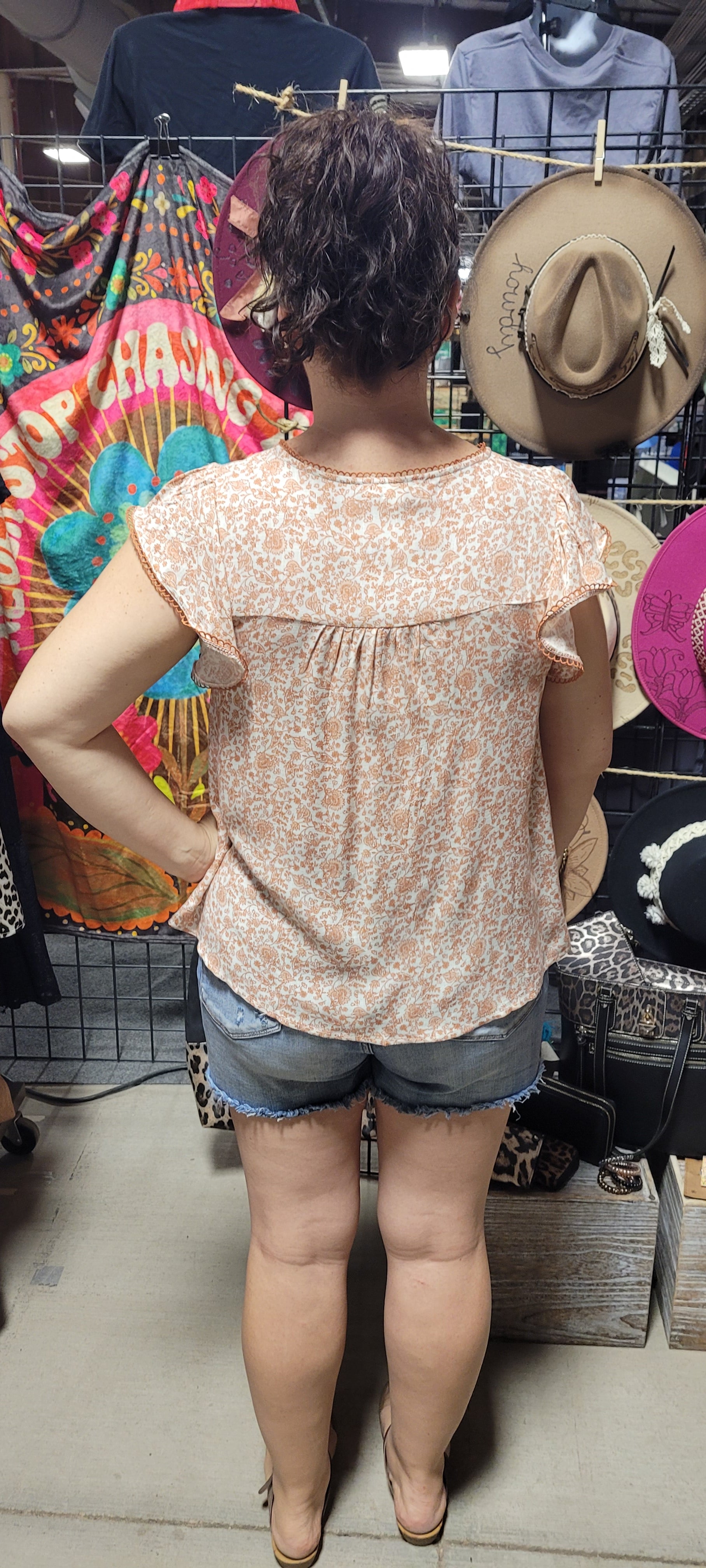 Dress to impress with this soft and dreamy "Tina Dusty Peach" top! With a split round neckline, a front tie with keyhole, flirty short sleeves, and a front chest-line lace, you'll look like you stepped out of a fairy tale. Puttin' the "wow" into every outfit! Sizes small through large.