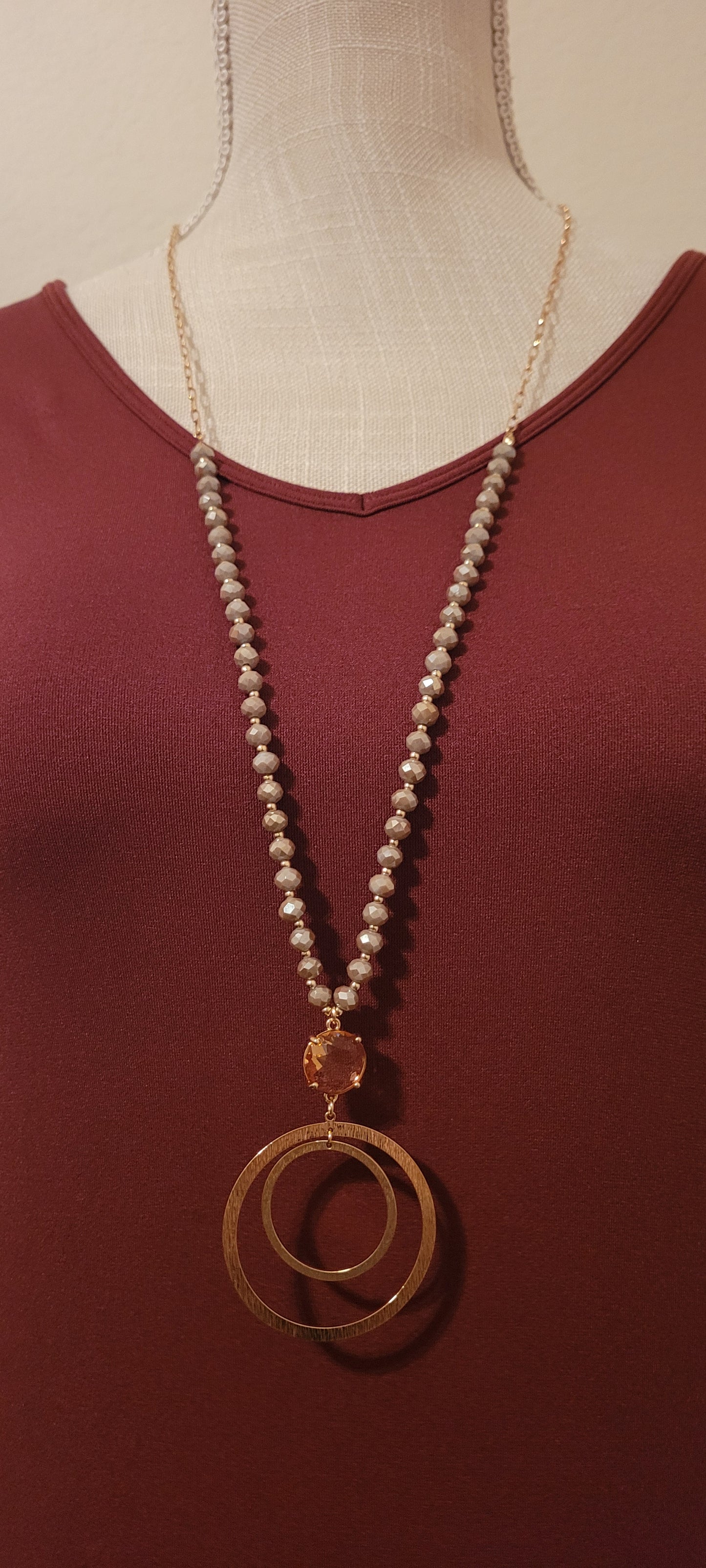 Approximate Length: Adjustable 32+2 inches Color: Gold link chain with taupe glass beads, peach crystal and floating circle pendants Limited supply!