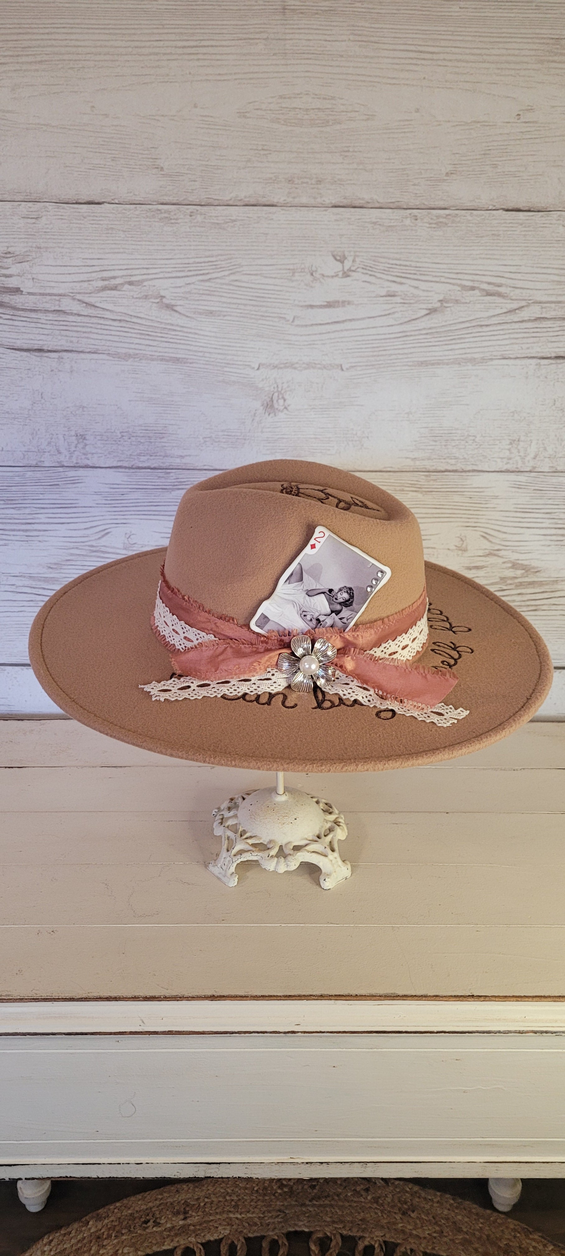 Features "I can by myself flowers" & flowers engraved Frayed rose ribbon, natural lace ribbon with flower brooch & playing card Felt hat Flat brim 65% polyester and 35% cotton Ribbon drawstring for hat size adjustment Head Circumference: 24" Crown Height: 5" Brim Length: 15.75" Brim Width: 14.5" Branded & numbered inside crown Custom burned & engraved by Kayla