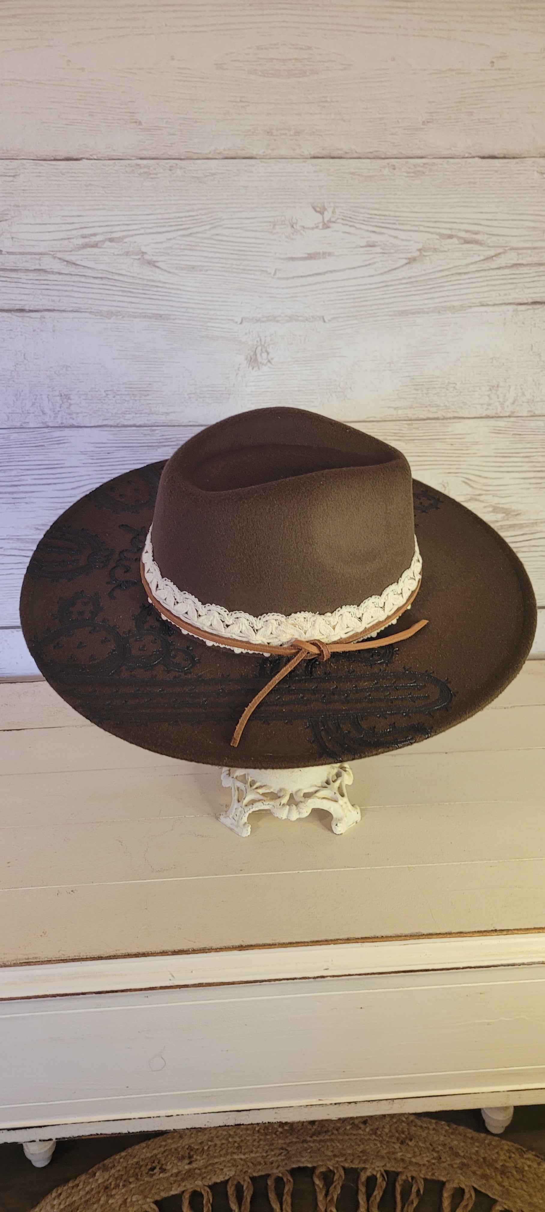 Features "don't be a prick", cactus & saguaro engraving Natural lace ribbon & leather band Felt hat Flat brim 65% polyester and 35% cotton Ribbon drawstring for hat size adjustment Head Circumference: 24" Crown Height: 5" Brim Length: 15.75" Brim Width: 14.5" Branded & numbered inside crown Custom designed by Kayla
